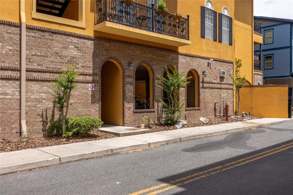 A kitchen with white cabinets, granite countertops, a white stove, and a white refrigerator — 325 NW 14TH STREET UNIT 307, GAINESVILLE, FL