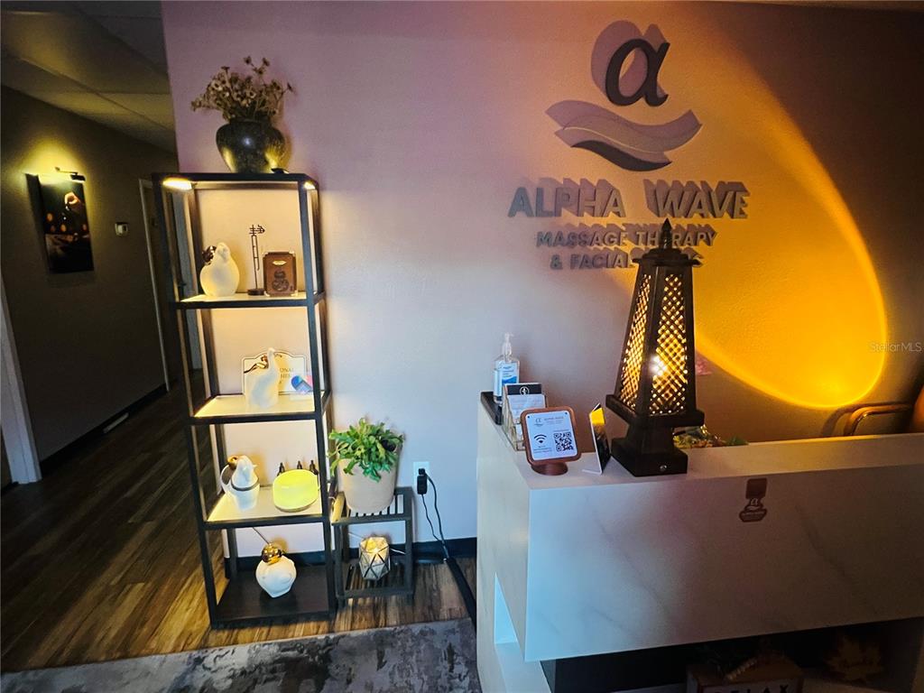 A reception area features a branded wall, a tall display shelf, and a front desk — 5207 26TH STREET W, BRADENTON, FL