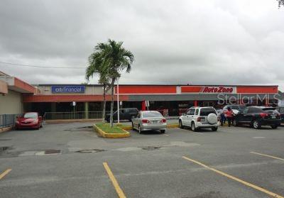 A parking lot sits in front of a strip mall with AutoZone and CitiFinancial storefronts — 97 SATURNINO RODRIGUEZ #97, YABUCOA, PR