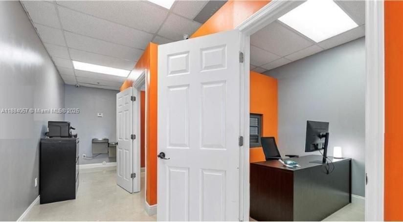 An office interior features a white door, orange accent walls, and a dark desk — 100 N State Road 7 # 203A, Margate FL 33063, MARGATE, FL