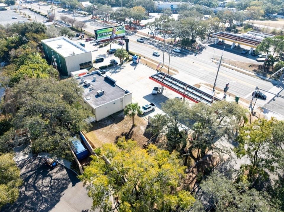 An aerial view shows a commercial property with a gas station and adjacent building — 2202 E BEARSS AVENUE, TAMPA, FL