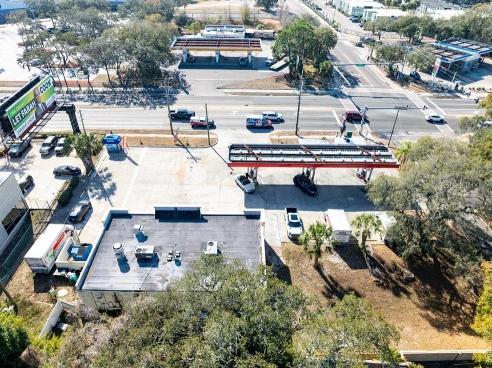 An aerial view shows a commercial property with a gas station, parking lot, and building — 2202 E BEARSS AVENUE, TAMPA, FL