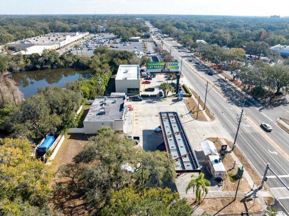 An aerial view shows a commercial property with a gas station canopy and a billboard — 2202 E BEARSS AVENUE, TAMPA, FL