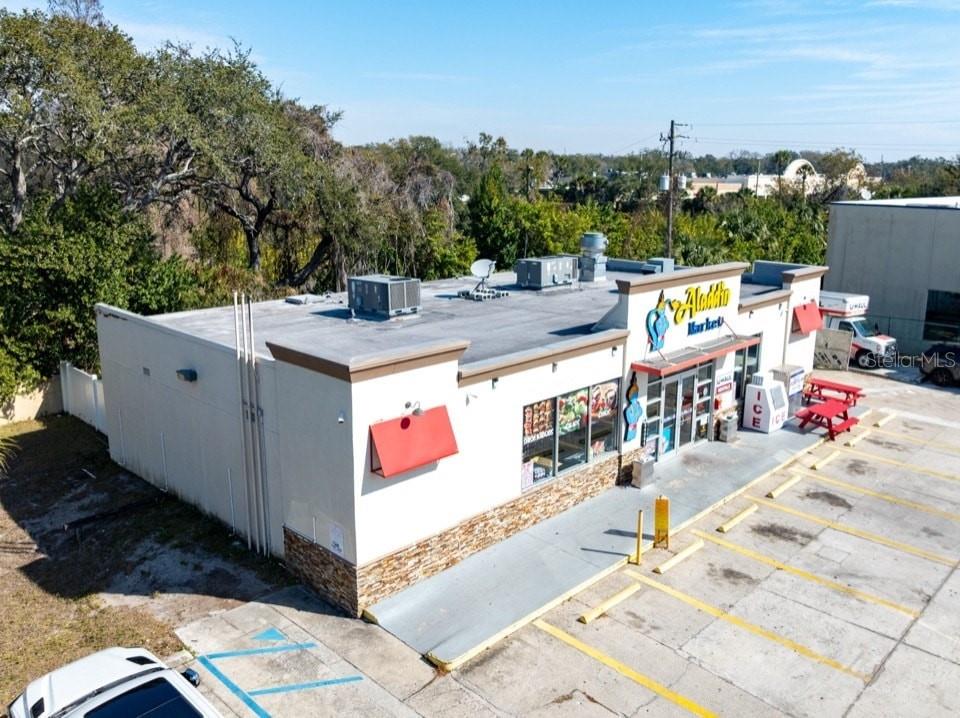 An aerial view shows the exterior of a commercial building with a parking lot — 2202 E BEARSS AVENUE, TAMPA, FL