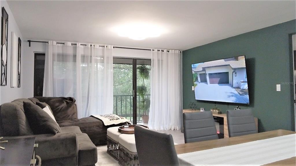 An exterior view of a multi-story apartment building surrounded by large, mature trees — 1036 BONAIRE DRIVE UNIT 2836, ALTAMONTE SPRINGS, FL