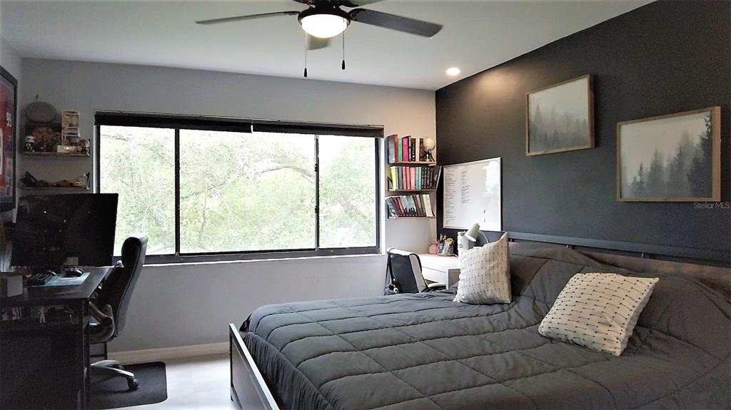 A dining area and living room feature gray walls, a sectional sofa, and sliding glass doors — 1036 BONAIRE DRIVE UNIT 2836, ALTAMONTE SPRINGS, FL
