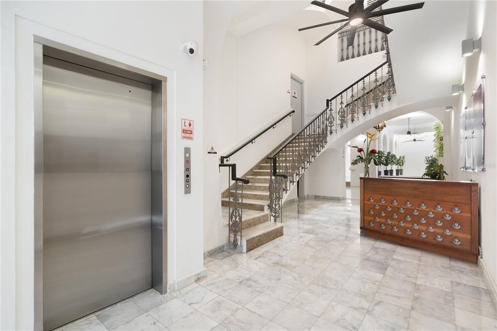 A lobby features a stainless steel elevator, a marble staircase with iron railings, and mailboxes — 205 LUNA, OLD SAN JUAN, PR