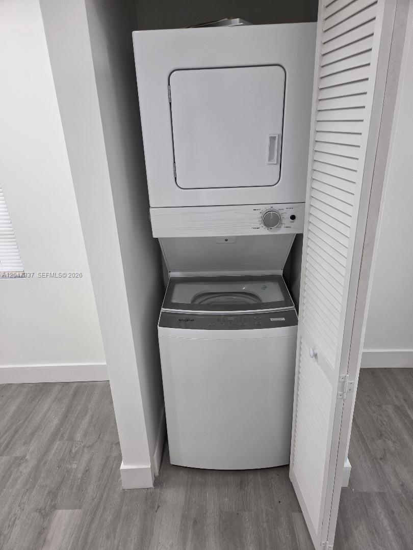 A white stacked washer and dryer unit is located inside a small closet — 2911 NW 30th St, Miami FL 33142, MIAMI, FL