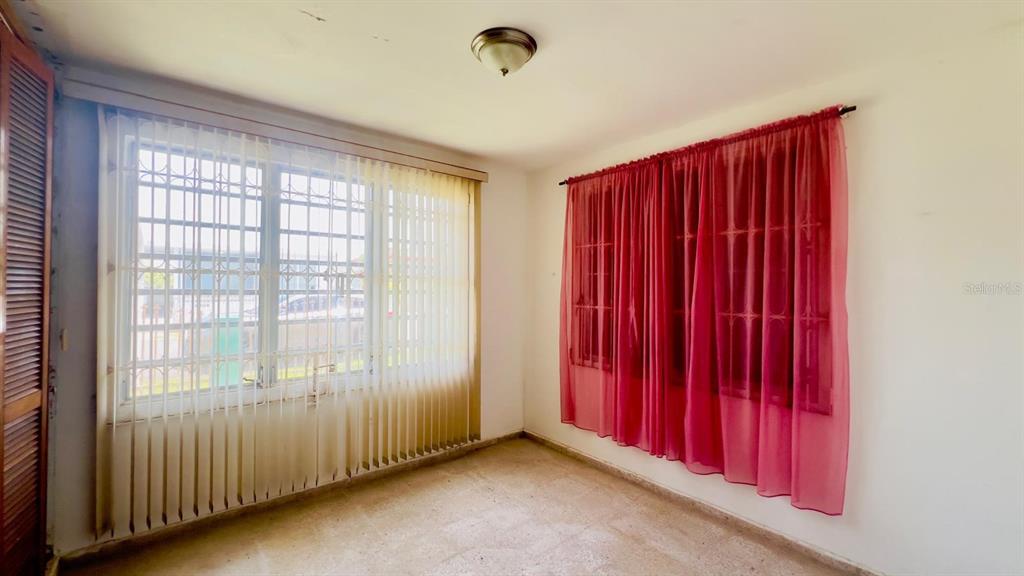 A room with white walls, tile flooring, a ceiling light, and two windows with coverings — #9 CALLE REPARTO GONZALEZ, AGUADA, PR
