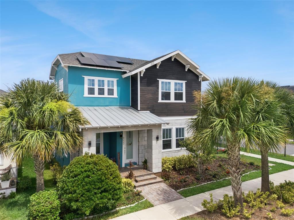 An aerial view shows a residential house with solar panels on its roof — 8033 NEMOURS PARKWAY, ORLANDO, FL