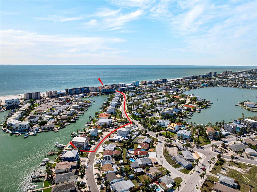 This aerial view shows a coastal neighborhood with a red line highlighting a street — 449 S BAYSHORE DRIVE, MADEIRA BEACH, FL