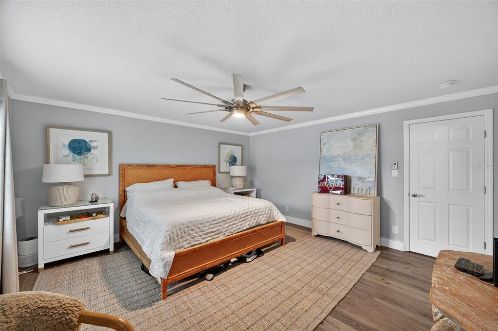 A bedroom features a woven bed frame, a ceiling fan, and two white dressers — 4924 BEACH DRIVE SE UNIT F, ST PETERSBURG, FL