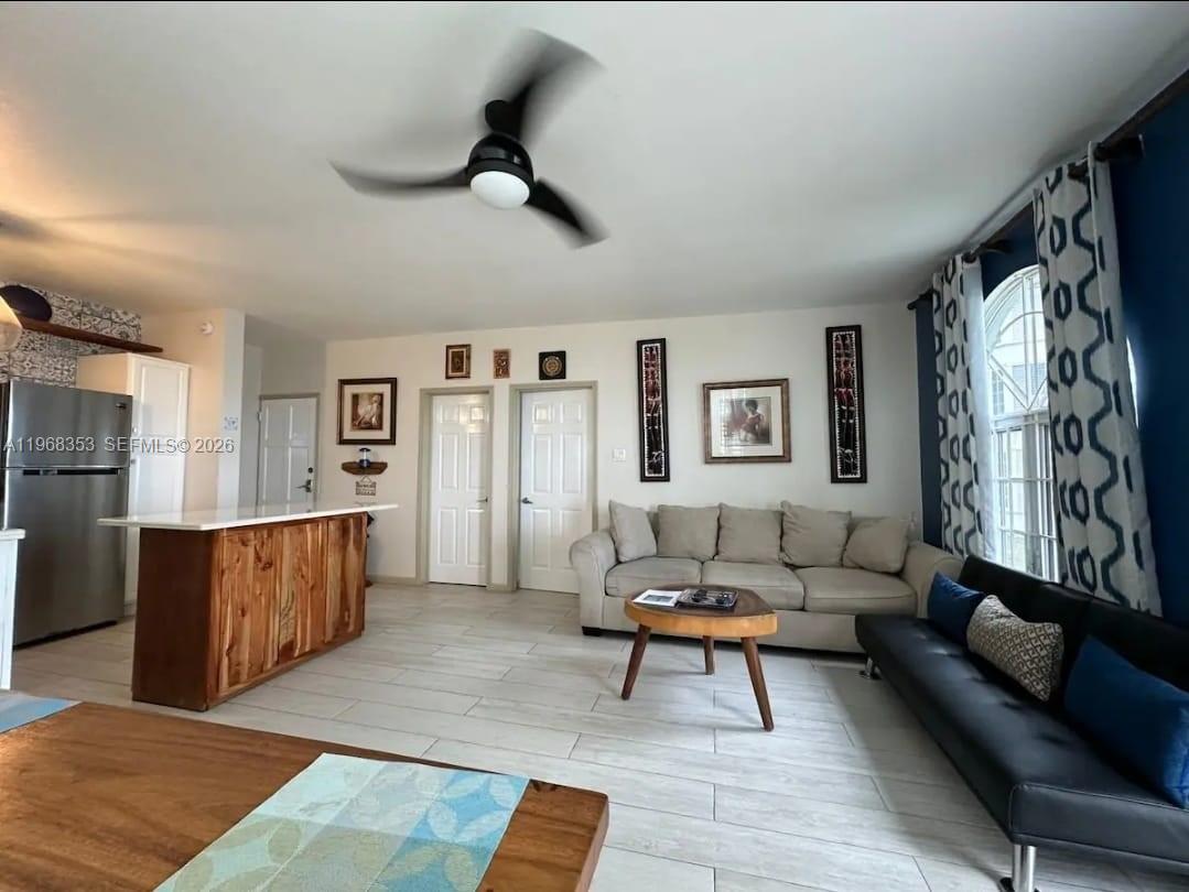 A living room with a kitchen island, light tile flooring, and a ceiling fan — 00 Sky Castles, Ocho Rios # 00, FL, FL