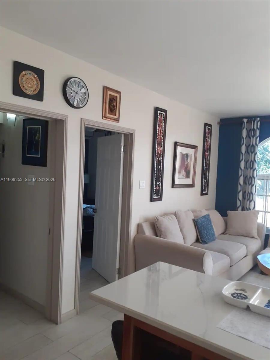 A living room features a beige sofa, wall art, and a white countertop in the foreground — 00 Sky Castles, Ocho Rios # 00, FL, FL