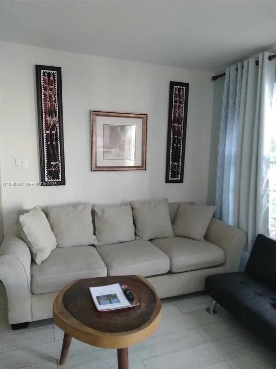 A living room features a beige sofa, a wood-slice coffee table, and wall art — 00 Sky Castles, Ocho Rios # 00, FL, FL