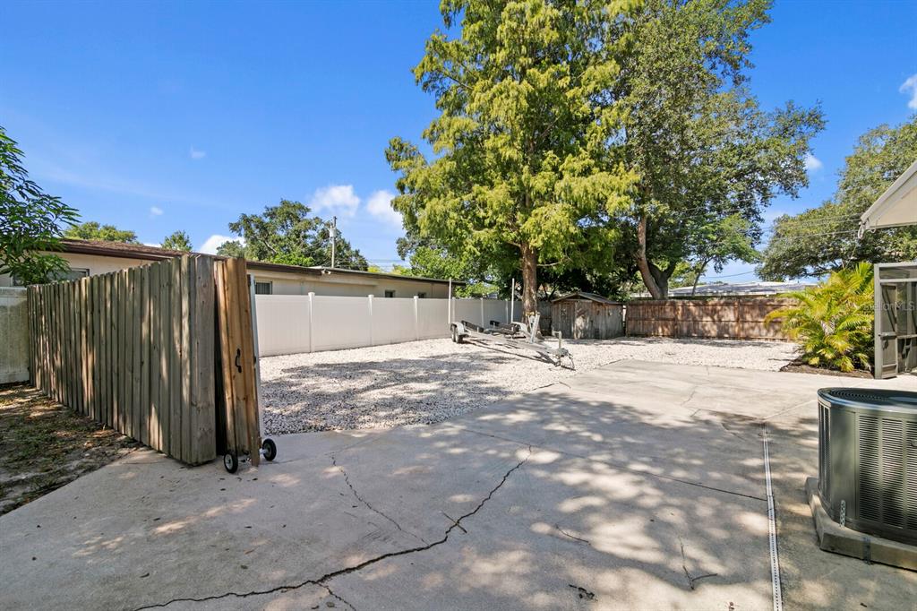 A screened-in patio features a tiki bar with three blue stools and decorative license plates — 2168 VICTORIA DRIVE, CLEARWATER, FL