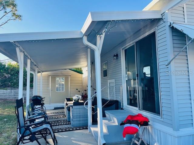 A covered patio area features outdoor furniture, a small shed, and a sliding glass door — 2429 LIMEWOOD AVENUE, CLERMONT, FL