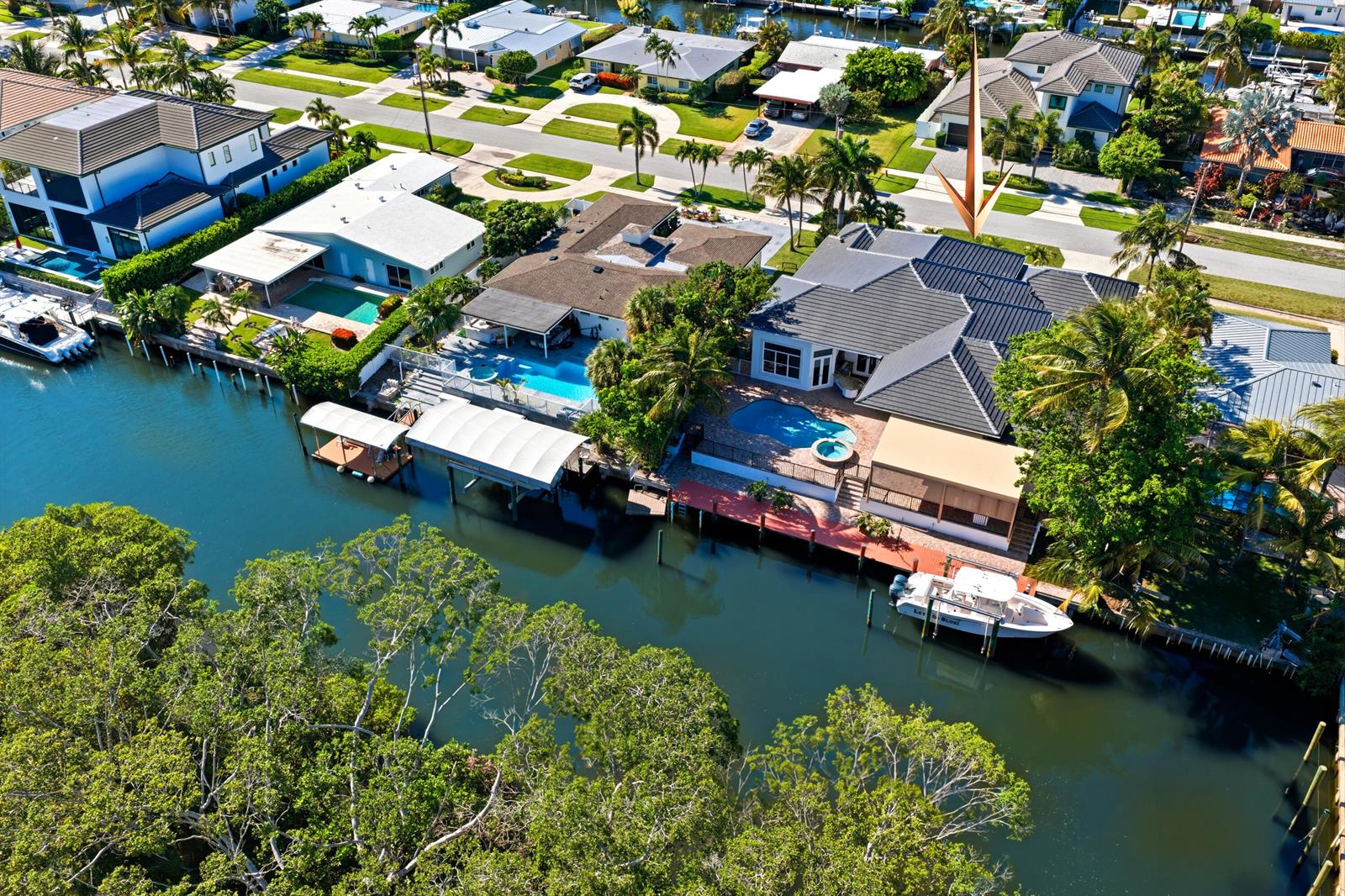 An aerial view shows waterfront houses with swimming pools, boat docks, and lush landscaping — 608 Inlet Road, North Palm Beach FL 33408, NORTH PALM BEACH, FL