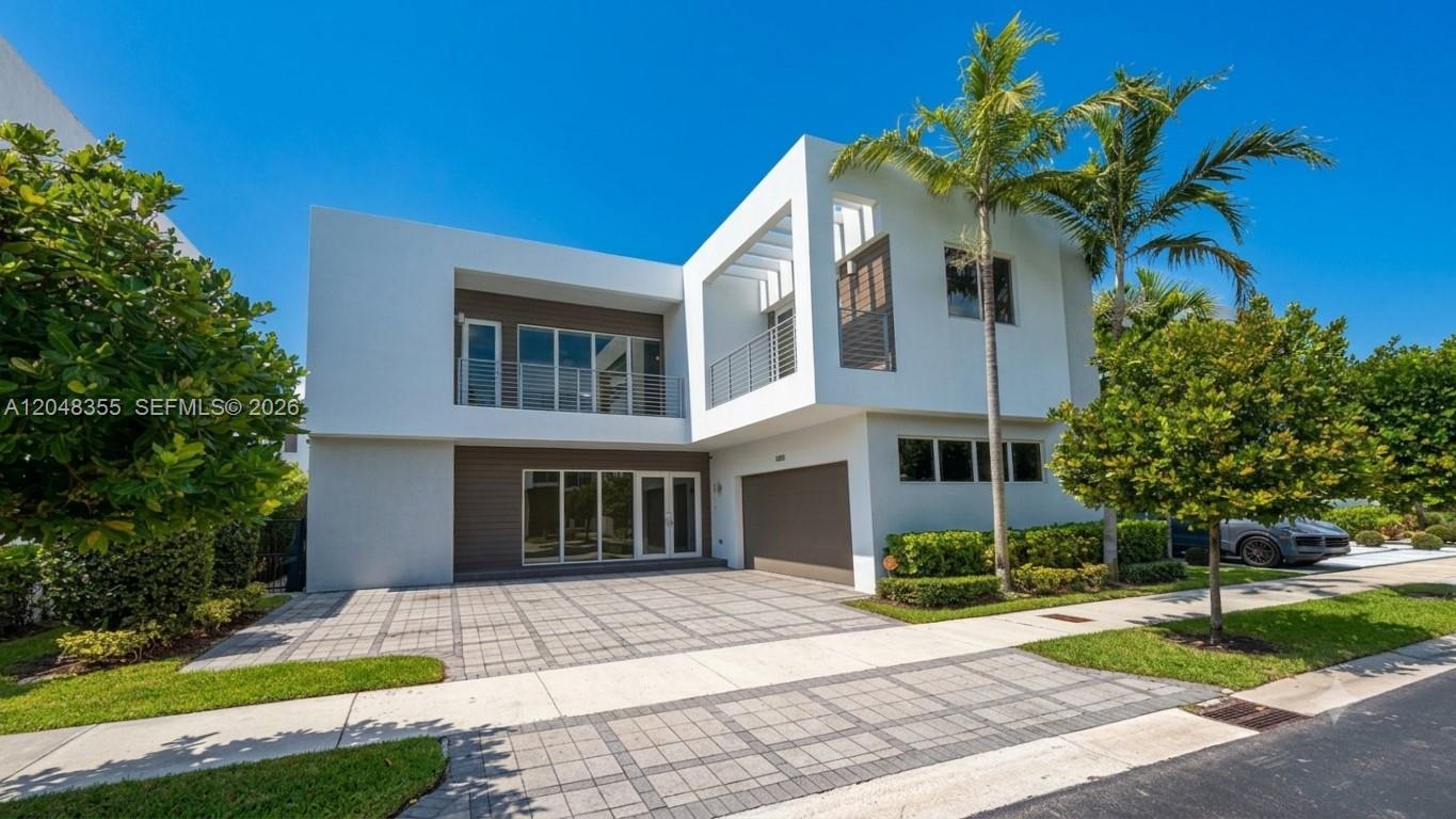 A modern two-story house with a white exterior, flat roof, and a paved driveway — 10108 NW 77th St # 10108, Doral FL 33178, DORAL, FL