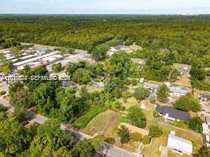 An aerial view shows a vacant residential lot surrounded by trees and neighboring houses — 0 SE 45 street, Gainesville FL 32641, GAINESVILLE, FL