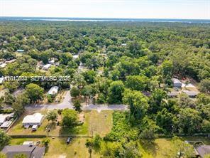 An aerial view shows a residential neighborhood with houses surrounded by dense green trees — 0 SE 45 street, Gainesville FL 32641, GAINESVILLE, FL