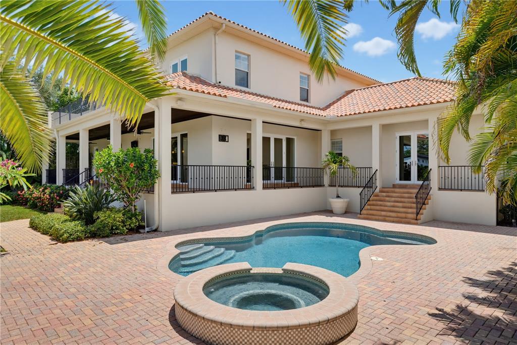 A two-story house with a pool, hot tub, and brick patio under palm trees — 2212 S OCCIDENT STREET, TAMPA, FL