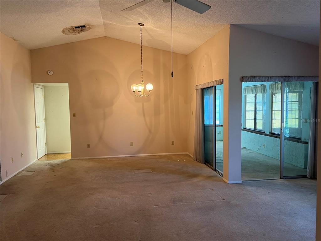 A front entrance with a storm door, a side window with shutters, and a sidelight — 10738 LAZY LAKE DR, ORLANDO, FL