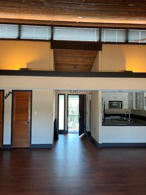 An interior view shows a living area with wood floors, a wood-paneled ceiling, and entryway — 808 PINEWOOD COURT UNIT 3138/9, HAINES CITY, FL