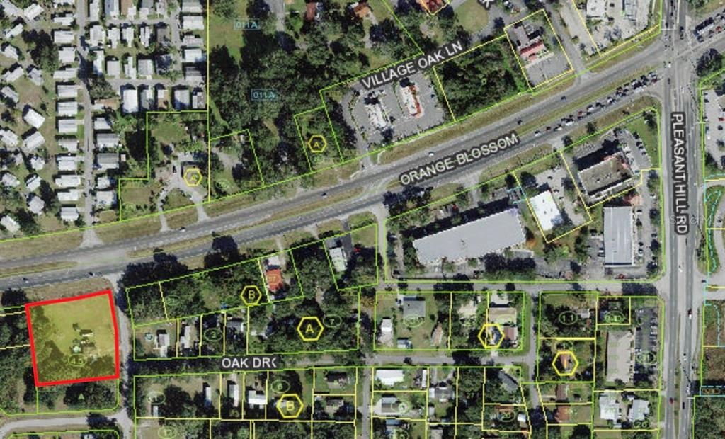 This is an aerial map showing a property outlined in red near a major road intersection — 1670 ORANGE LANE, KISSIMMEE, FL