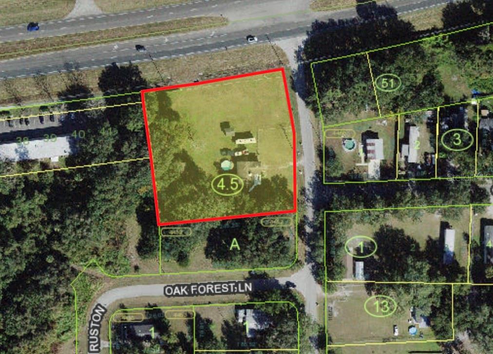 This is an aerial map showing a highlighted rectangular property lot and surrounding residential parcels — 1670 ORANGE LANE, KISSIMMEE, FL