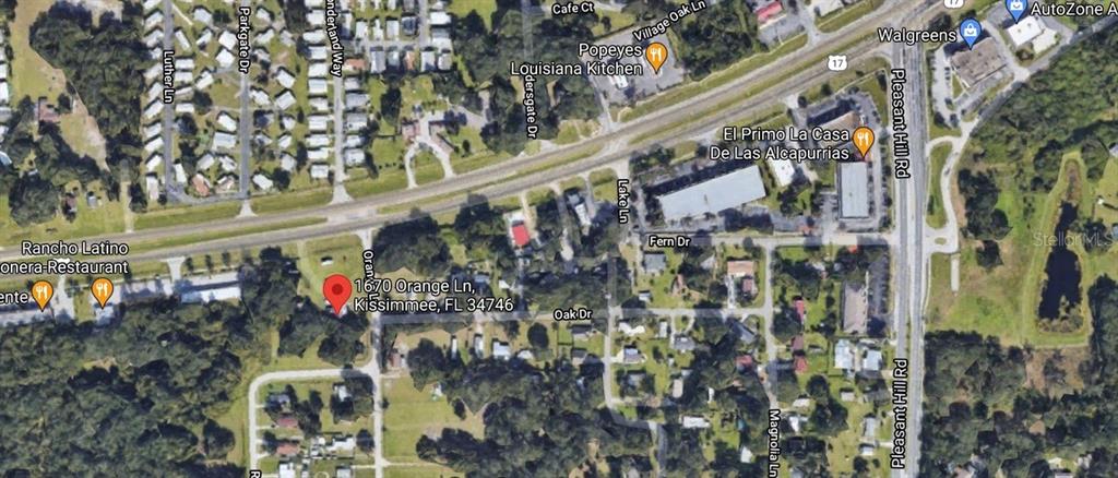 This is a satellite map view showing a residential area in Kissimmee, Florida — 1670 ORANGE LANE, KISSIMMEE, FL