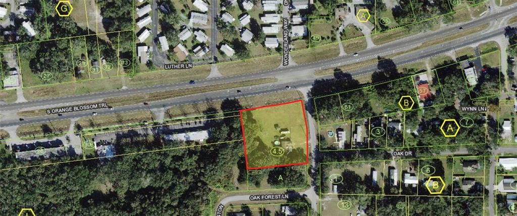 An aerial map shows a rectangular property outlined in red near a major highway intersection — 1670 ORANGE LANE, KISSIMMEE, FL