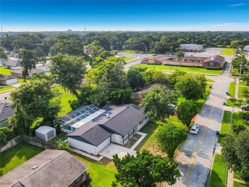 An aerial view of a single-story house with a screened-in pool and a fenced yard — 605 WILLIAMSBURG DRIVE, DAYTONA BEACH, FL