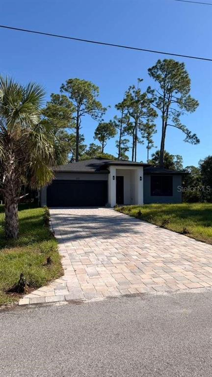 A single-story house with a dark roof, gray exterior, and a paved driveway — 2816 SILAS AVENUE, NORTH PORT, FL