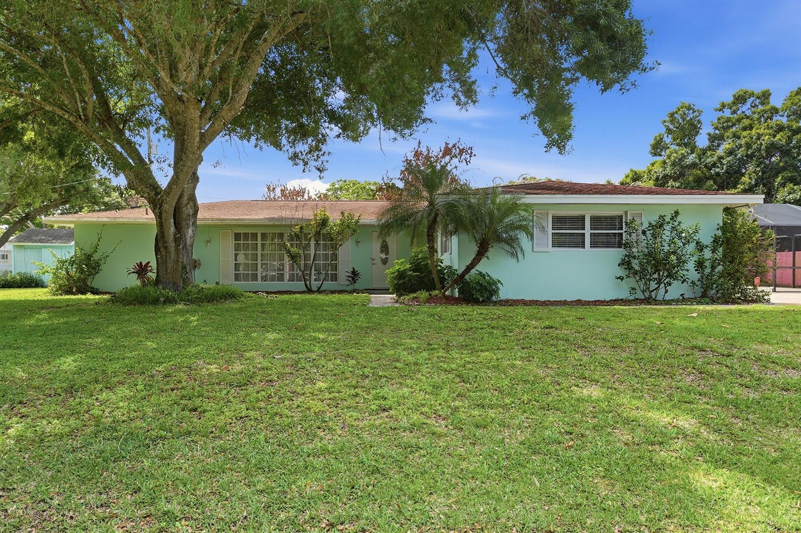 A single-story light green house with a large front lawn and a mature tree — 2115 15th Place, Vero Beach FL 32960, VERO BEACH, FL