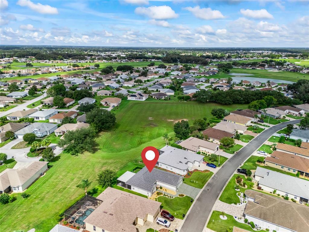 An aerial view shows a residential neighborhood with a red location pin over a house — 12211 SE 175TH LOOP, SUMMERFIELD, FL