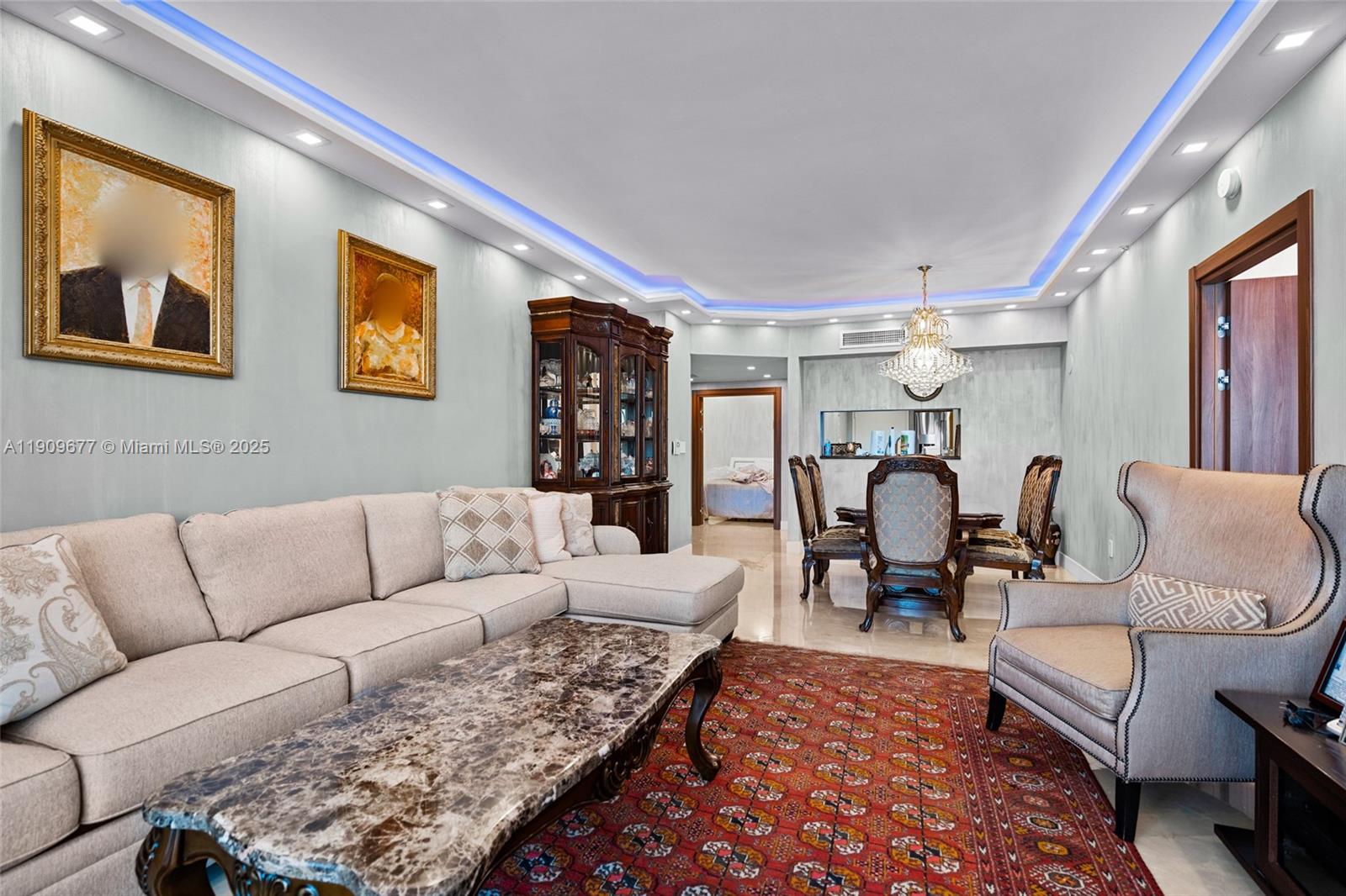 A living and dining area features a sectional sofa, marble coffee table, and patterned rug — 9559 Collins Ave # F, Surfside FL 33154, SURFSIDE, FL