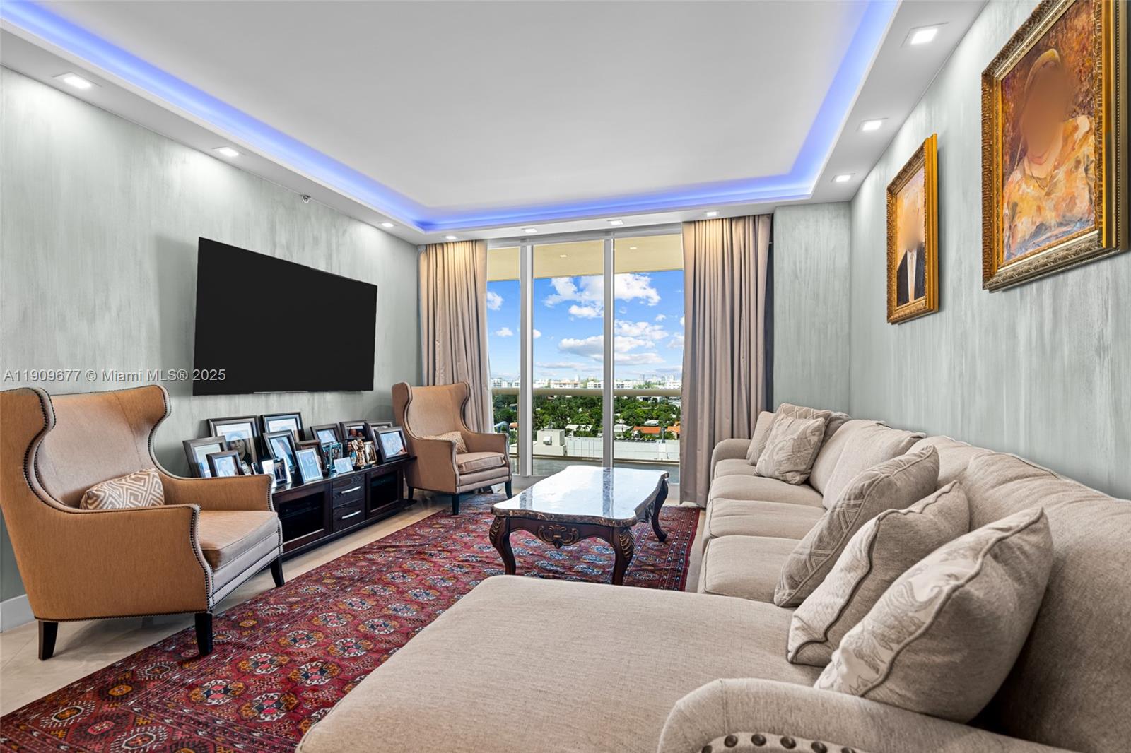 A living room features a large sectional sofa, two armchairs, a patterned rug, and balcony views — 9559 Collins Ave # F, Surfside FL 33154, SURFSIDE, FL