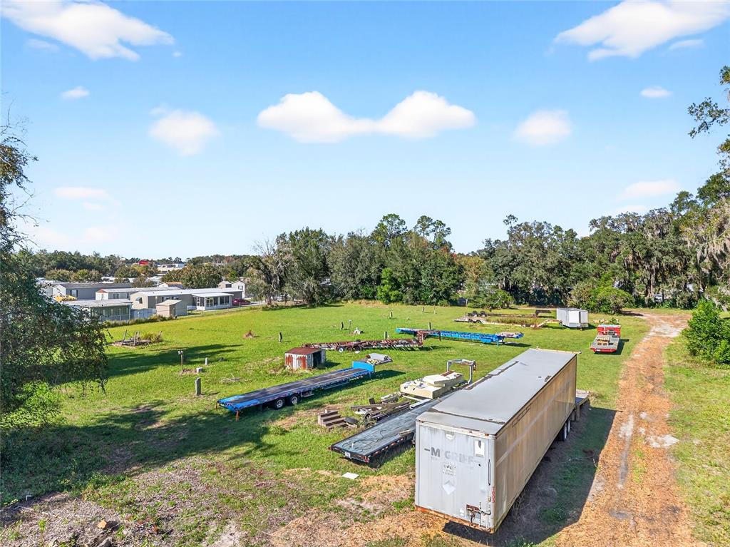 An aerial view of a grassy lot containing several trailers and storage containers — 10389 SE 50TH AVENUE, BELLEVIEW, FL