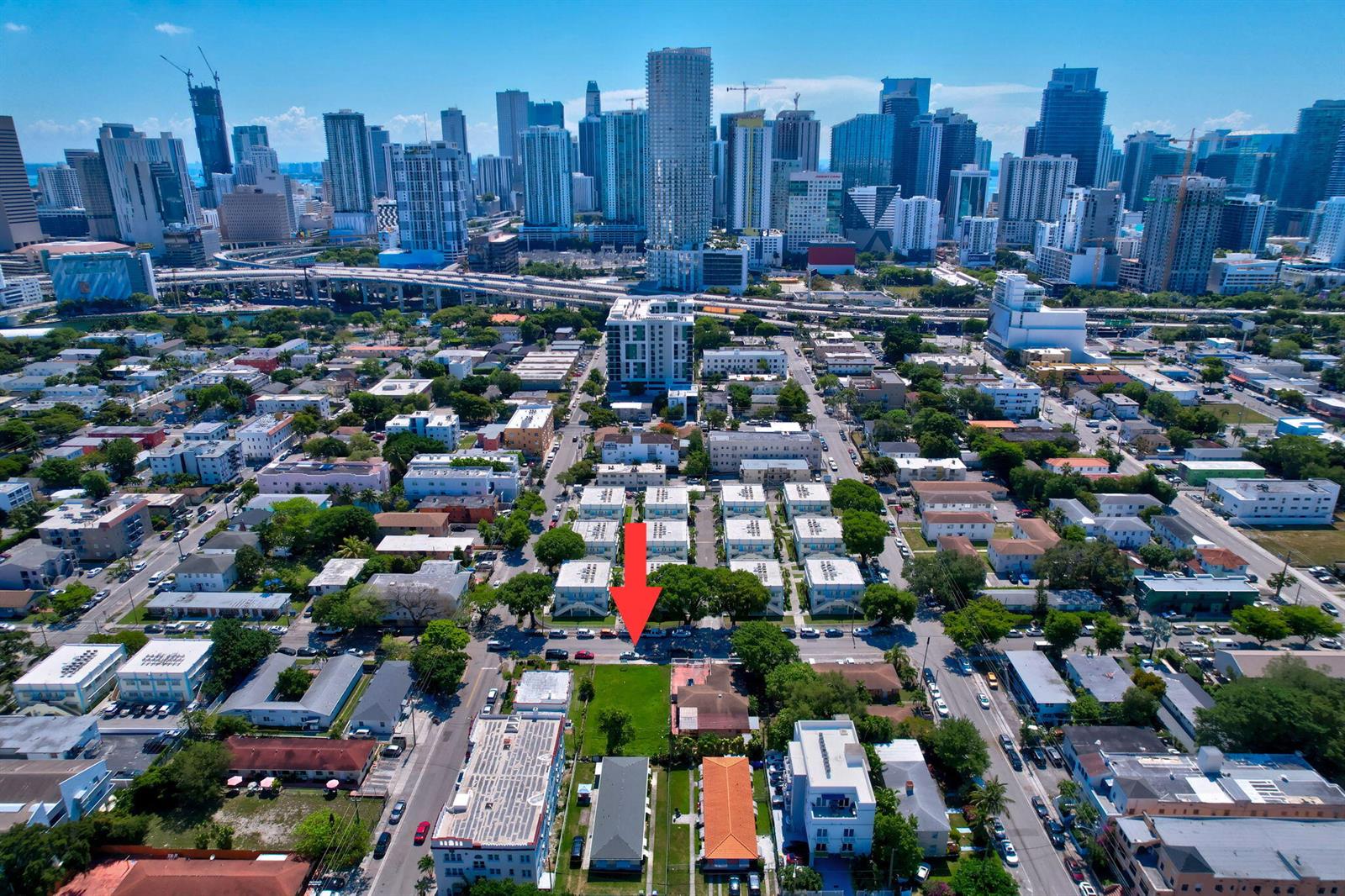 An aerial view of a city neighborhood with a red arrow pointing toward a lot — 512 SW 6th Avenue, Miami FL 33130, MIAMI, FL
