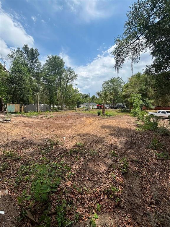 A cleared, dirt-covered residential lot is surrounded by trees and a white pickup truck — 7480 LAKEVIEW STREET, KEYSTONE HEIGHTS, FL