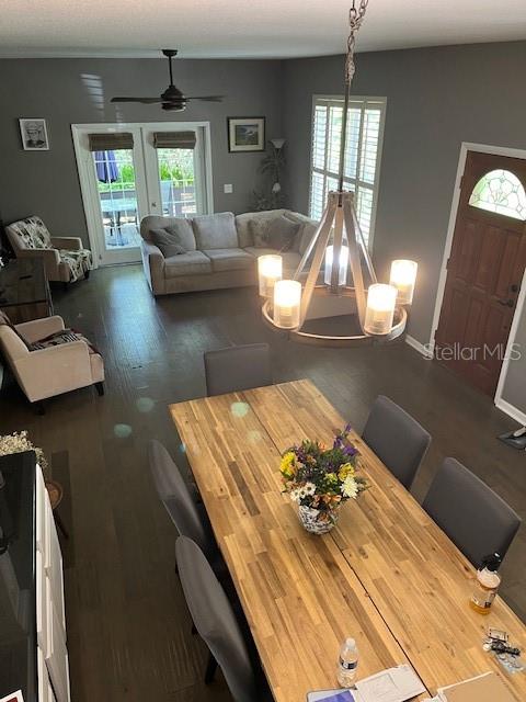 An open-concept dining and living area features a wooden table, chandelier, and gray sectional sofa — 14202 NELL DRIVE, ORLANDO, FL