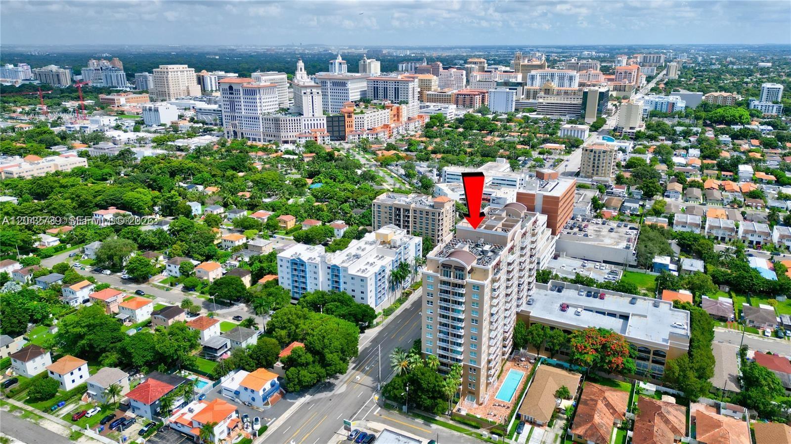 An aerial view shows a tall residential building with a red arrow pointing downward — 2665 SW 37th Ave # 101, Miami FL 33133, MIAMI, FL