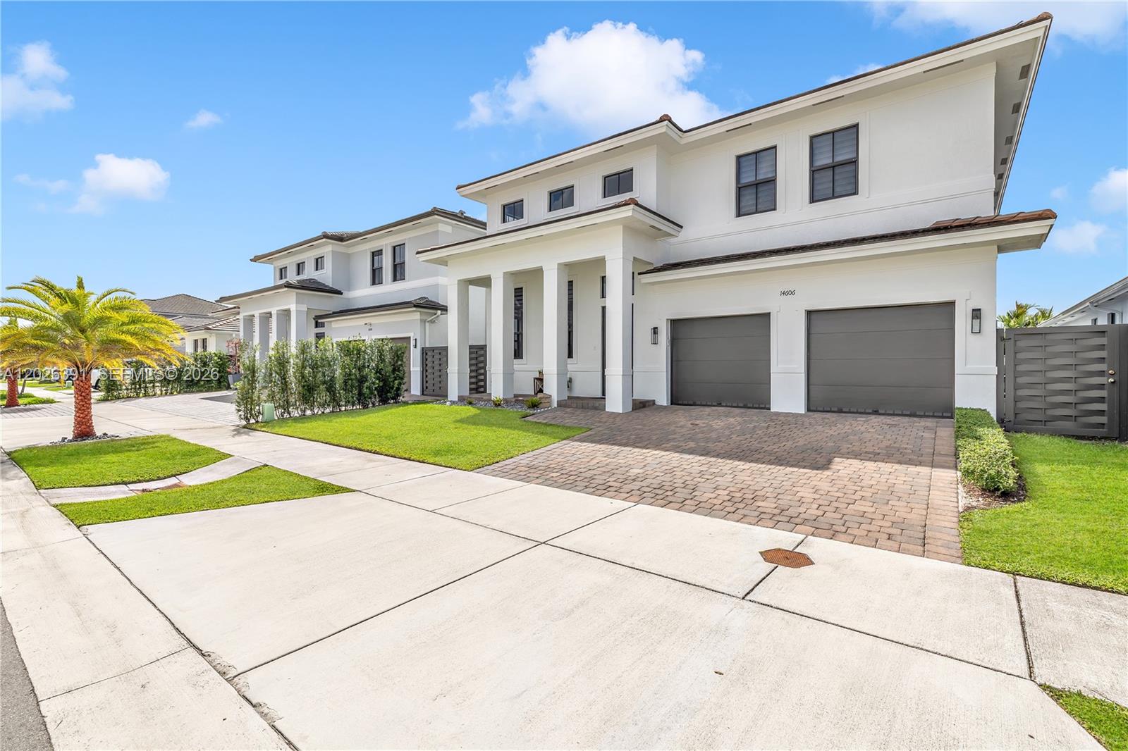 A two-story white house with a two-car garage and a paved driveway — 14606 SW 22nd Ter, Miami FL 33175, MIAMI, FL