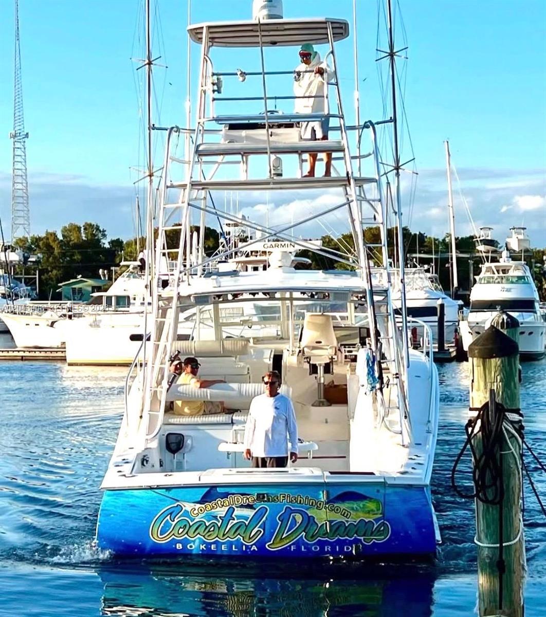 A sport fishing boat named Coastal Dreams is docked at a marina — 1313 Ocean Bay Dr, Key Largo FL 33037, KEY LARGO, FL