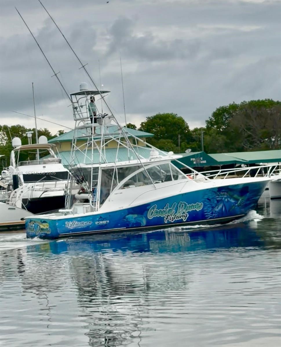 A sport fishing boat with a tuna tower cruises on the water near a marina — 1313 Ocean Bay Dr, Key Largo FL 33037, KEY LARGO, FL