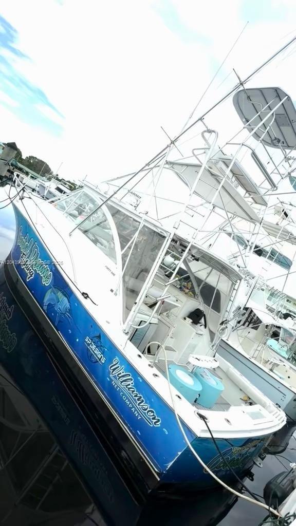 A blue and white sport fishing boat is docked at a marina — 1313 Ocean Bay Dr, Key Largo FL 33037, KEY LARGO, FL