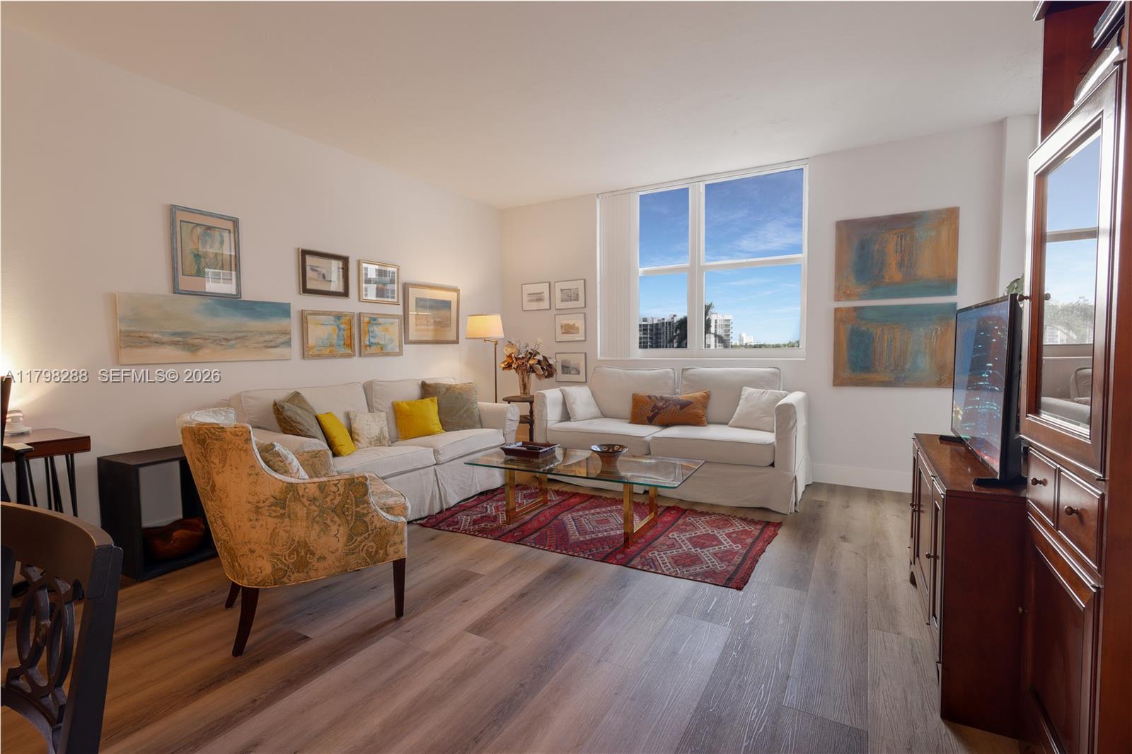A living room features two white sofas, a glass coffee table, and large windows — 3001 S Ocean Dr # 443, Hollywood FL 33019, HOLLYWOOD, FL