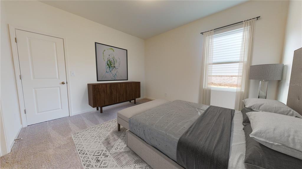 A bedroom features a bed with a gray cover, a wooden dresser, and a window — 13256 BENDING CREEK TRAIL, PARRISH, FL