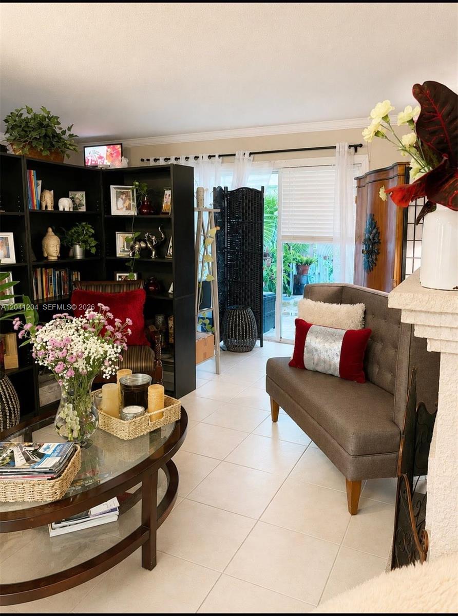 A living room features a glass coffee table, a dark bookshelf, and a gray settee — 13918 SW 172nd Ter, Miami FL 33177, MIAMI, FL